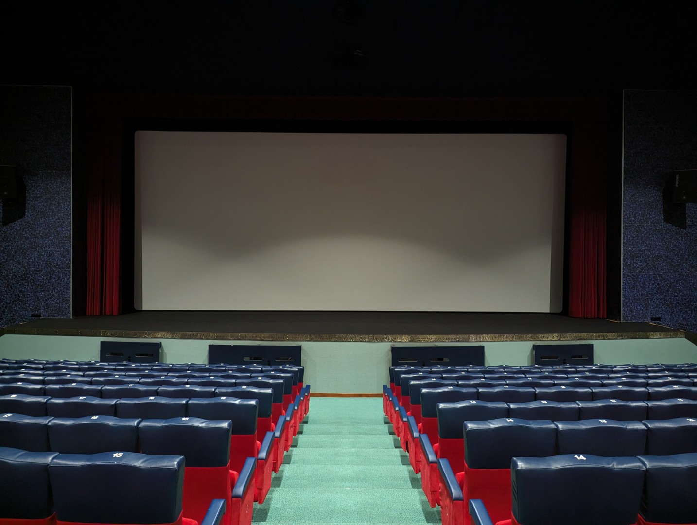 Interior of the cinema hall with red vintage seats